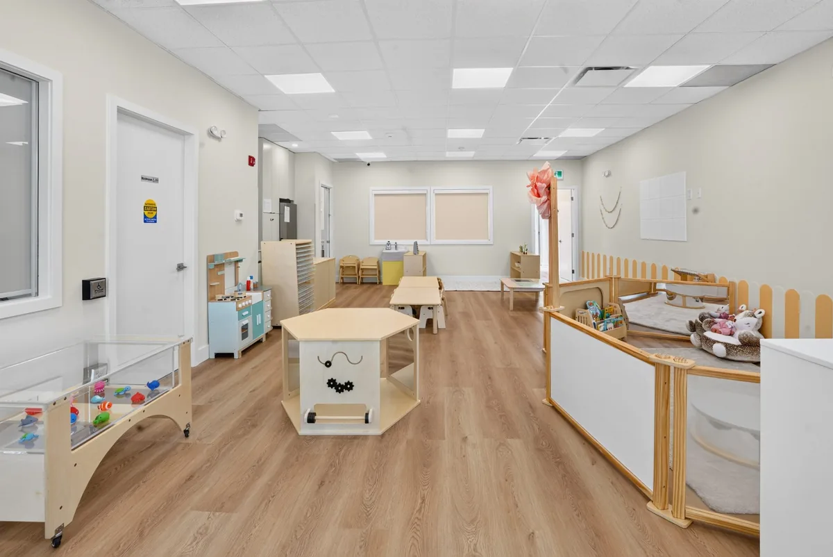 MIM playroom with a sensory table, play kitchen and toddler climbing corner