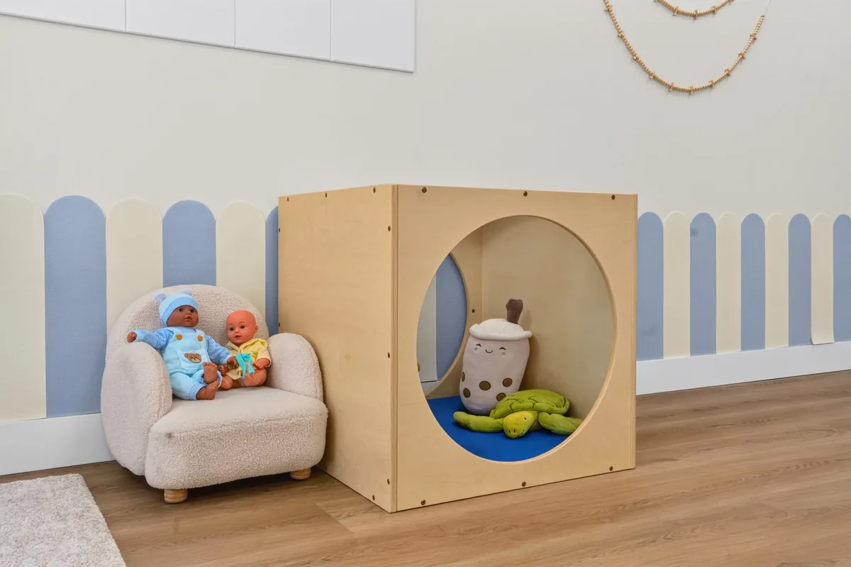 Cozy crawl-through nook and a small armchair with baby dolls