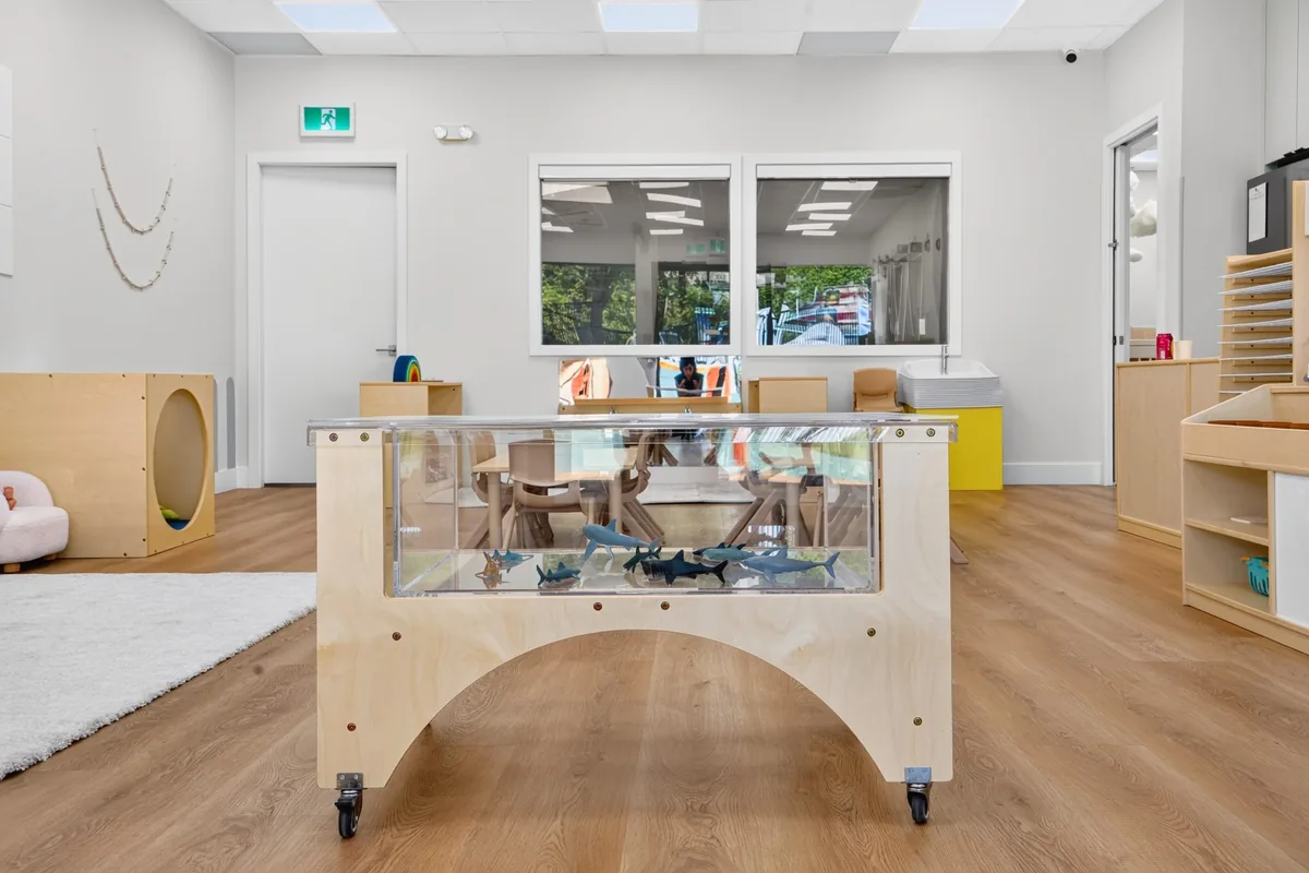 Clear sensory table on wheels in a calm MIM classroom