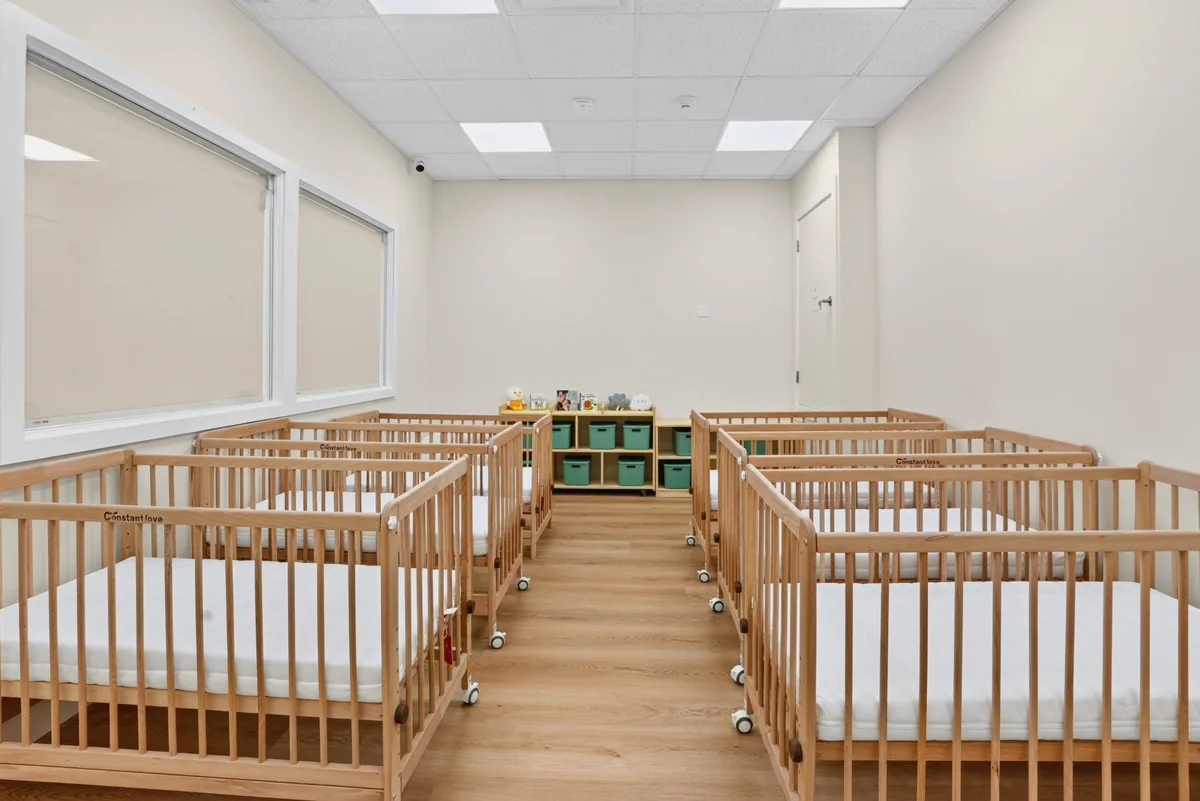 Infant sleep room with individual wooden cribs