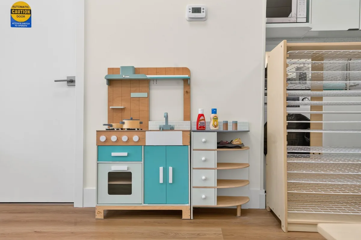 Wooden pretend-play kitchen in pastel mint and cream